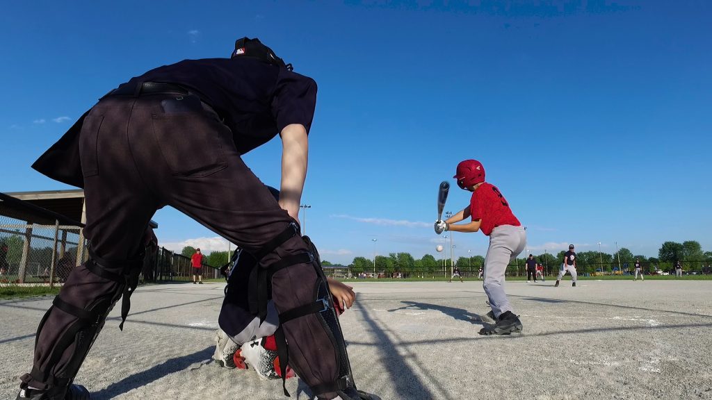 boy up to bat at a baseball diamond