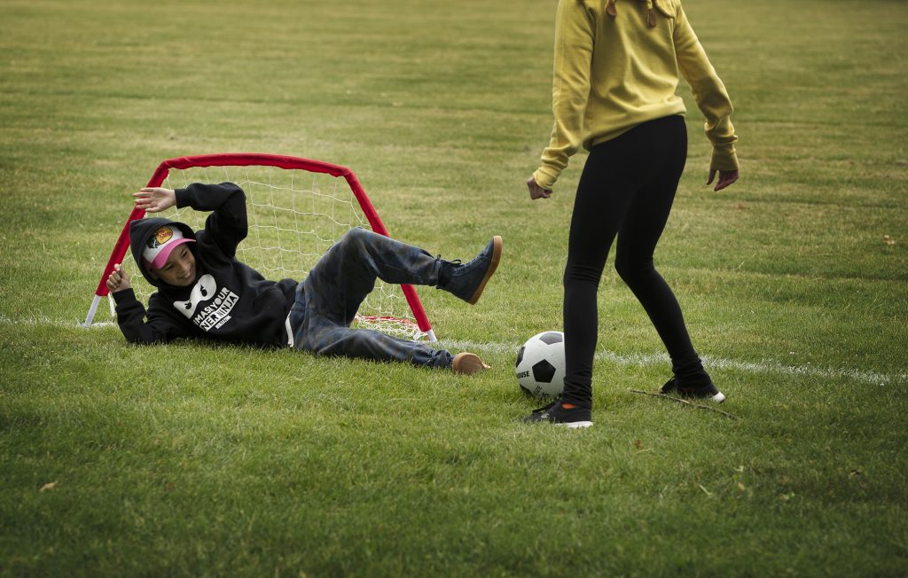 Two children playing soccer.