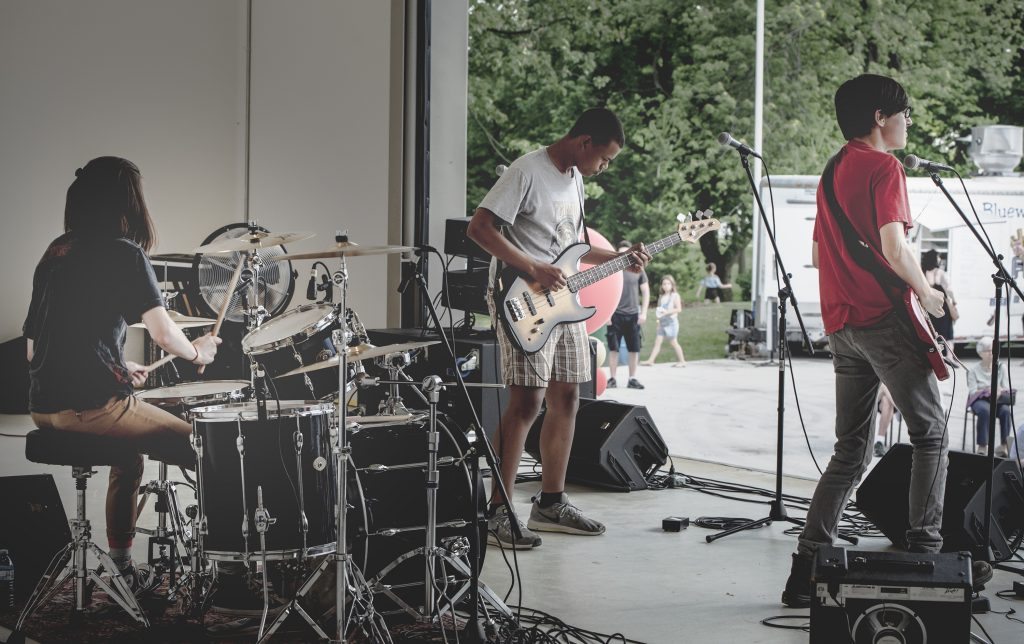 Band performing on the Suncor Agora stage in Centennial Park.