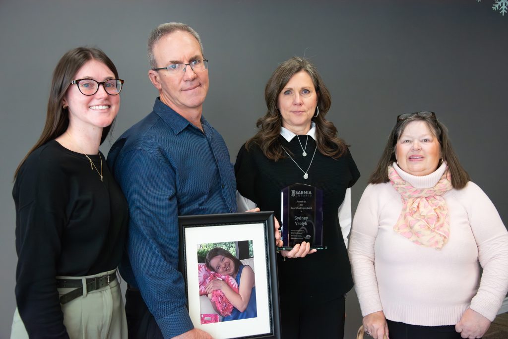The Kevin Schenk Legacy Award posthumously recognized Sydney Vrolyk, whose family accepted the award in her honour. Pictured are from left: sister Abby Vrolyk, father John Vrolyk, mother Helen Van Sligtenhorst, and Kathleen Stinson of the Sarnia Accessibility Advisory Committee